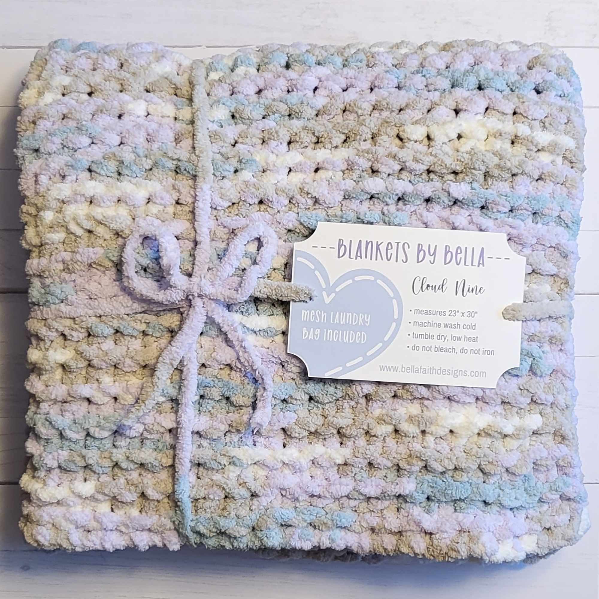 A handmade crochet baby blanket with pastel color soft yarn.